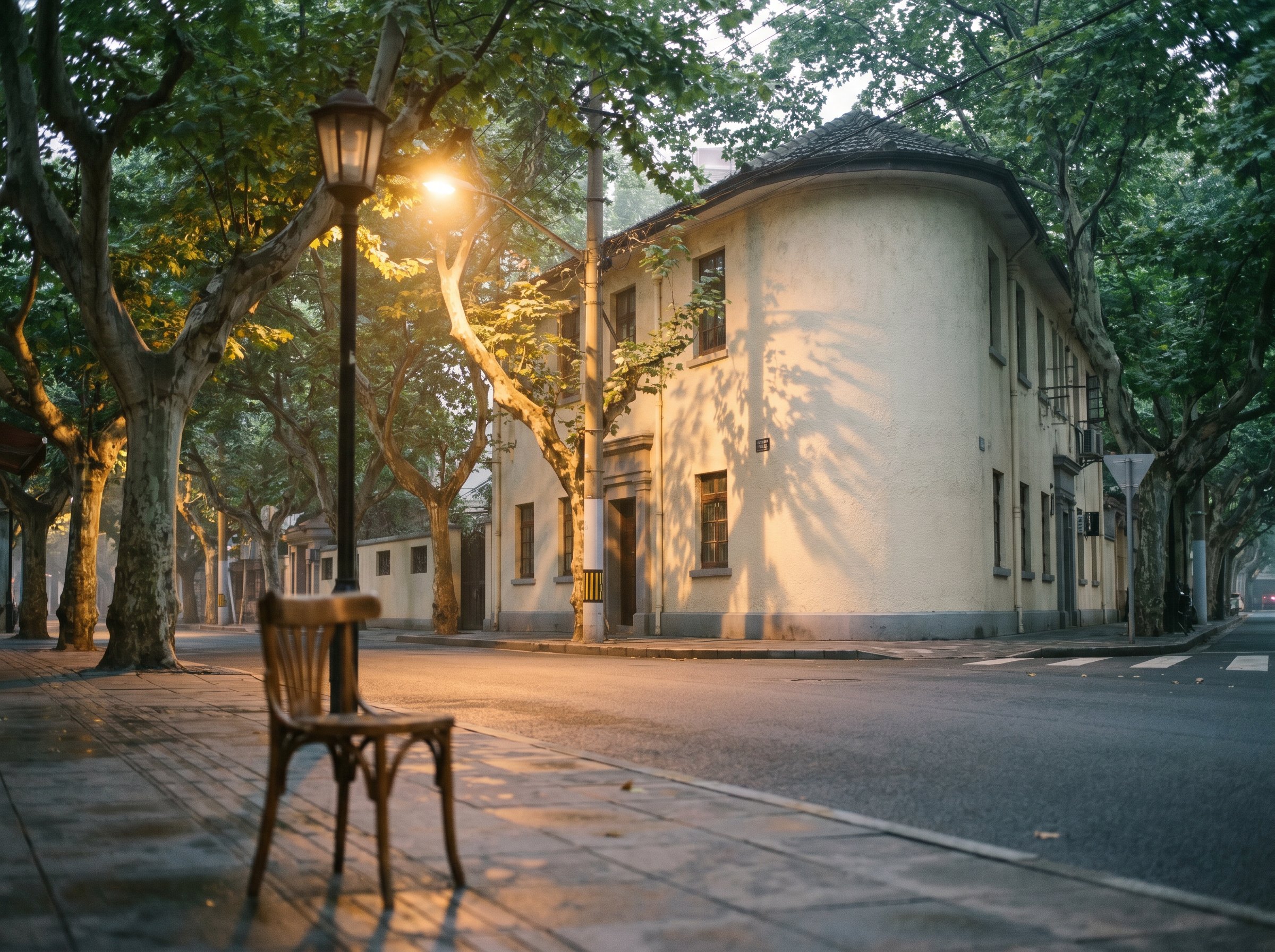 Wukang Road in the late evening, the plane-tree-shadows still on the cream-stucco facade