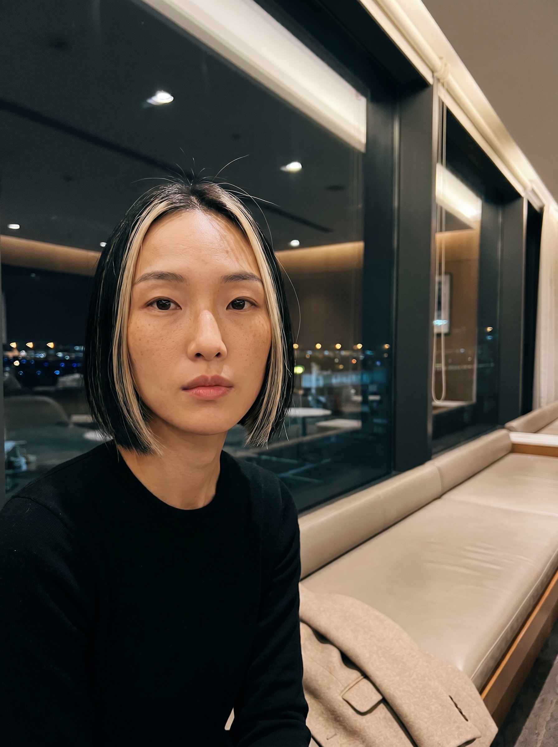 Yuki at the PVG business-lounge window, twenty-two-thirty CST, the long day folded